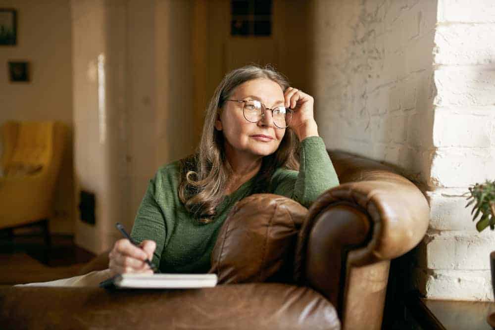 Woman trying to focus while writing