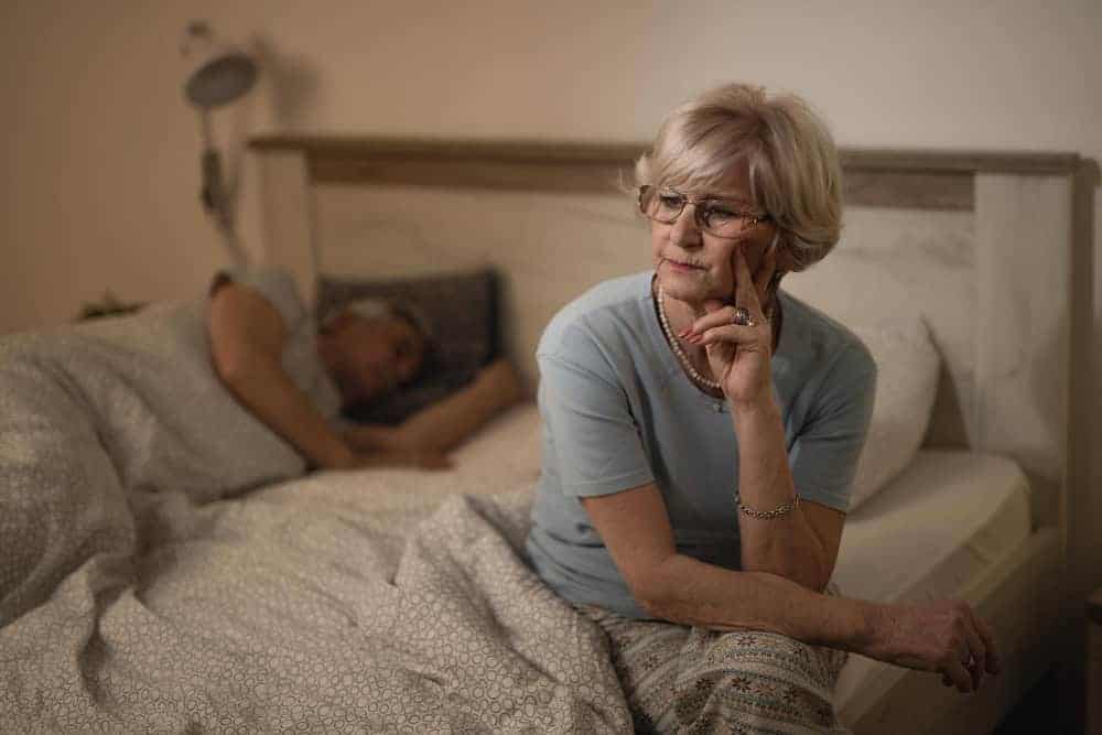 Woman sitting quietly on a bed
