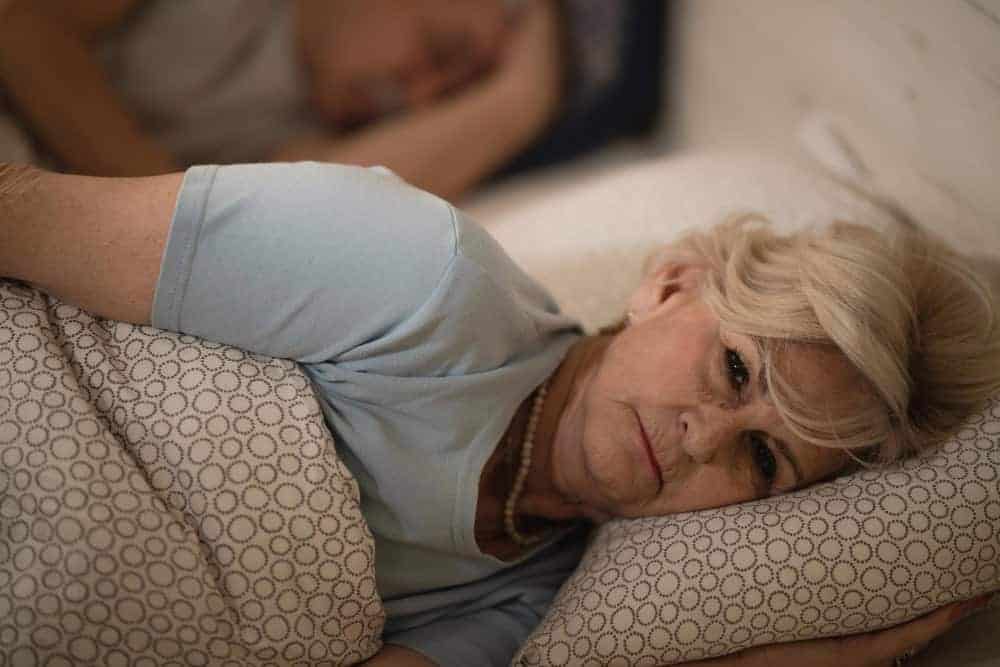 Woman awake in bed at night